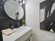 Stylish half bath with a modern sink, textured wall, and decorative mirror, creating an elegant space at 2324 Brookview Ct, Rock Hill, SC 29732