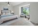 Sunlit main bedroom with a large window, comfortable seating area, and a beautifully styled bed at 2324 Brookview Ct, Rock Hill, SC 29732