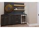 Stylish bar area with dark wood cabinets, open shelving, and a built-in wine refrigerator at 2413 Cross Country Rd, Charlotte, NC 28270