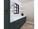 Chic butler's pantry featuring stylish blue cabinets, open shelving, and sleek countertop at 2413 Cross Country Rd, Charlotte, NC 28270