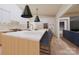 Modern kitchen with white cabinets, a spacious island with seating, and stainless steel appliances at 2413 Cross Country Rd, Charlotte, NC 28270