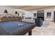 Open-concept living room with a pool table, comfortable seating, and a modern fireplace at 2413 Cross Country Rd, Charlotte, NC 28270