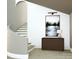 Elegant staircase with white steps and a curved wall, complemented by a modern light fixture and wall art at 2413 Cross Country Rd, Charlotte, NC 28270
