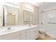 Bright bathroom with dual sinks, white cabinetry, and a shower/tub combination at 2561 26Th Ne Ave, Hickory, NC 28601