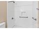 Clean and accessible shower area featuring white tile, grab bars, and updated fixtures at 2561 26Th Ne Ave, Hickory, NC 28601