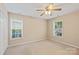 Bright, carpeted bedroom with two windows providing lots of natural light and neutral paint at 2561 26Th Ne Ave, Hickory, NC 28601