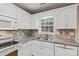 Close up of the kitchen sink with granite counters, tile backsplash, and stainless steel appliances at 2561 26Th Ne Ave, Hickory, NC 28601
