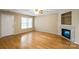 Bright room with bamboo flooring, ceiling fan, fireplace, and view of the front yard at 2561 26Th Ne Ave, Hickory, NC 28601