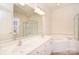 Bright bathroom featuring a double sink vanity, large mirror, separate shower, and soaking tub at 3814 Misty Glen Ct, Matthews, NC 28105