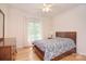 Bedroom featuring a bed, dresser, mirror, ceiling fan and natural light from the window at 3814 Misty Glen Ct, Matthews, NC 28105