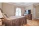 Bedroom with hardwood floors, large windows, and a media center at 3814 Misty Glen Ct, Matthews, NC 28105