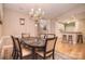 Dining area featuring a chandelier, a dining table, and hardwood floors at 3814 Misty Glen Ct, Matthews, NC 28105