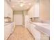 Bright kitchen featuring all-white cabinetry, modern appliances, and tile flooring at 3814 Misty Glen Ct, Matthews, NC 28105