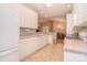Open kitchen layout with white cabinets and appliances, adjacent to dining area at 3814 Misty Glen Ct, Matthews, NC 28105