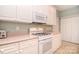 Well-equipped kitchen with white cabinets and appliances, including a gas range at 3814 Misty Glen Ct, Matthews, NC 28105