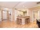 Open-concept living area featuring hardwood floors and a bar top at 3814 Misty Glen Ct, Matthews, NC 28105