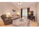 Cozy living room with vaulted ceiling, ceiling fan, and bright natural light at 3814 Misty Glen Ct, Matthews, NC 28105