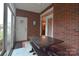 Enclosed brick patio with a dark wood table and bench at 3814 Misty Glen Ct, Matthews, NC 28105