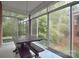 Enclosed sunroom offers tranquil views and ample space for dining and relaxing at 3814 Misty Glen Ct, Matthews, NC 28105