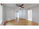Well-lit bedroom showcasing wood-look flooring, a ceiling fan, and ample closet space at 401 Lake Club Dr, Rock Hill, SC 29732