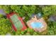Aerial view of a community pool and tennis court surrounded by lush greenery at 401 Lake Club Dr, Rock Hill, SC 29732