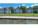 Lakeside condo community with a sandy beach area and well-maintained lawn, with beautiful landscaping at 401 Lake Club Dr, Rock Hill, SC 29732