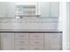 Close up on the kitchen's tile backsplash, gray countertops and cabinetry at 401 Lake Club Dr, Rock Hill, SC 29732