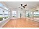 Bright living room featuring many windows with lovely water views, neutral paint, and wood flooring at 401 Lake Club Dr, Rock Hill, SC 29732