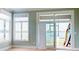 Bright living room with large windows offering serene lake views, and access to outdoor deck at 401 Lake Club Dr, Rock Hill, SC 29732