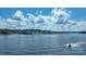 Expansive water view showcasing the waterfront condos and a jet ski enjoying the scenic landscape at 401 Lake Club Dr, Rock Hill, SC 29732