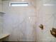 Modern shower with marble tile, built-in shelving, and bronze fixtures, offering a luxurious bathing experience at 4025 Foxes Trl, Cramerton, NC 28032