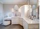 Elegant bathroom with marble countertops, dual sinks, vanity with mirrors, and stylish lighting at 4025 Foxes Trl, Cramerton, NC 28032