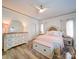 Charming bedroom featuring light neutral colors, wood flooring, and a chest at the foot of the bed at 4025 Foxes Trl, Cramerton, NC 28032