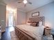Beautiful bedroom featuring neutral colors, a decorative ceiling fan, and a tufted headboard at 4025 Foxes Trl, Cramerton, NC 28032