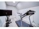 Bright exercise room with a treadmill, stationary bike, and laundry area at 4025 Foxes Trl, Cramerton, NC 28032