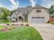Stunning home showcasing manicured landscaping, a stone and brick facade, and a three-car garage at 4025 Foxes Trl, Cramerton, NC 28032