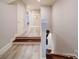 Hallway with hardwood floors, white trim, and access to upper and lower levels at 4025 Foxes Trl, Cramerton, NC 28032