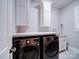 Modern laundry room with new front-load washer and dryer and built in cabinets at 4025 Foxes Trl, Cramerton, NC 28032