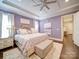 A lavender main bedroom features a tray ceiling, a ceiling fan, and carpet over hardwood flooring at 4025 Foxes Trl, Cramerton, NC 28032