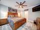 A lovely main bedroom featuring a wooden bed frame, ceiling fan, a mounted television and soft carpet at 4025 Foxes Trl, Cramerton, NC 28032