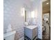 Stylish powder room boasting custom wallpaper, a decorative mirror, and modern fixtures at 4025 Foxes Trl, Cramerton, NC 28032