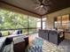 Inviting screened porch featuring comfortable seating and an outdoor dining area at 4025 Foxes Trl, Cramerton, NC 28032