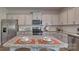 Spacious kitchen with stainless steel appliances, gray cabinets, granite countertops, and a center island at 4033 Cramer Estates Ct, Gastonia, NC 28056