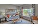 Bright living room with a stylish sofa, accent pillows, and a large window with decorative curtains at 4033 Cramer Estates Ct, Gastonia, NC 28056