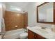 Bright bathroom with a shower-tub, wood vanity, and a large mirror at 4133 Hoffmeister Dr, Waxhaw, NC 28173