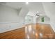 Large bonus room with lots of natural light, hardwood flooring, and wainscotting at 4133 Hoffmeister Dr, Waxhaw, NC 28173