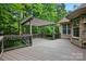 Enjoy this outdoor deck with wooden pergola and black metal railing overlooking the lush backyard at 4133 Hoffmeister Dr, Waxhaw, NC 28173