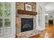 Close-up of the stone fireplace with a wooden mantel and elegant white trim at 4133 Hoffmeister Dr, Waxhaw, NC 28173