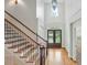Elegant foyer with hardwood floors, staircase, and a view of the front door at 4133 Hoffmeister Dr, Waxhaw, NC 28173