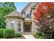 Stunning front entrance with double doors, brick accents, and manicured landscaping at 4133 Hoffmeister Dr, Waxhaw, NC 28173